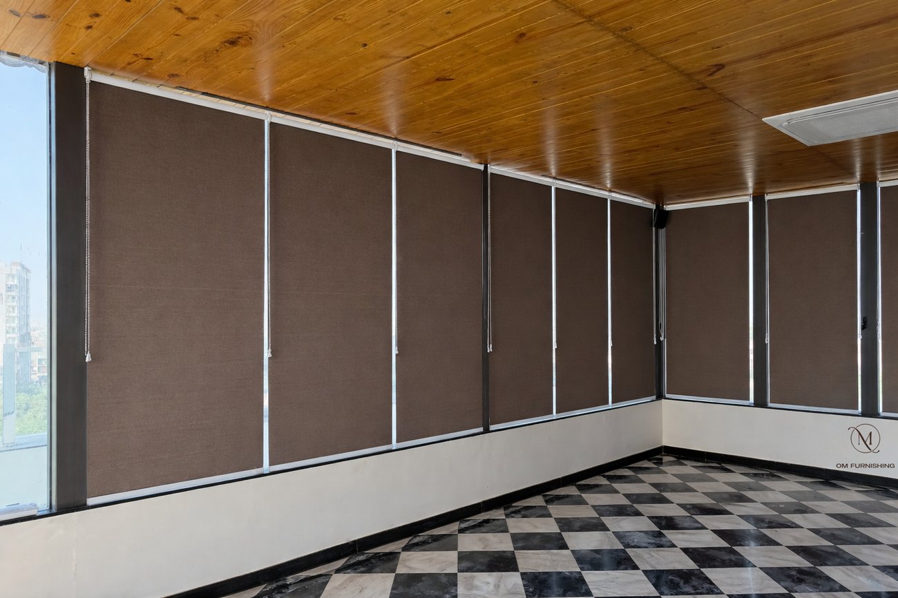 Brown roller blinds wrapping a room with checkerboard flooring