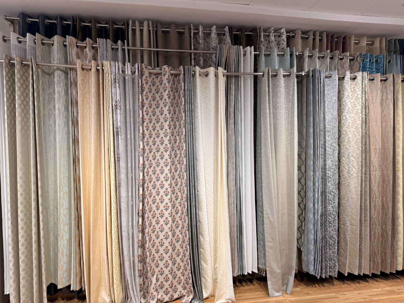 Wall of curtain fabric samples at OM Furnishing showroom