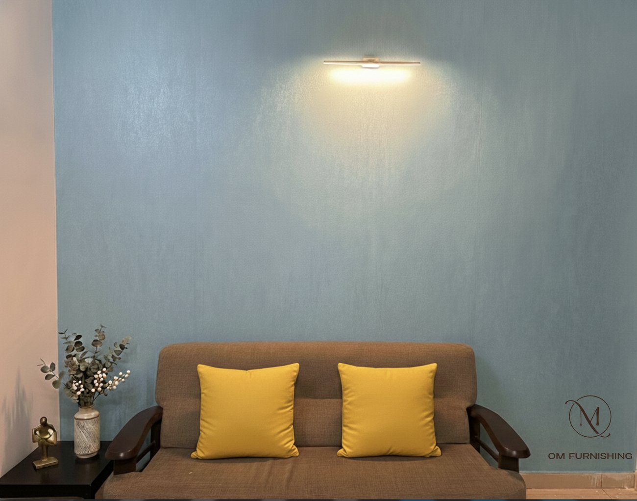 Sofa with yellow cushions against a blue accent wall