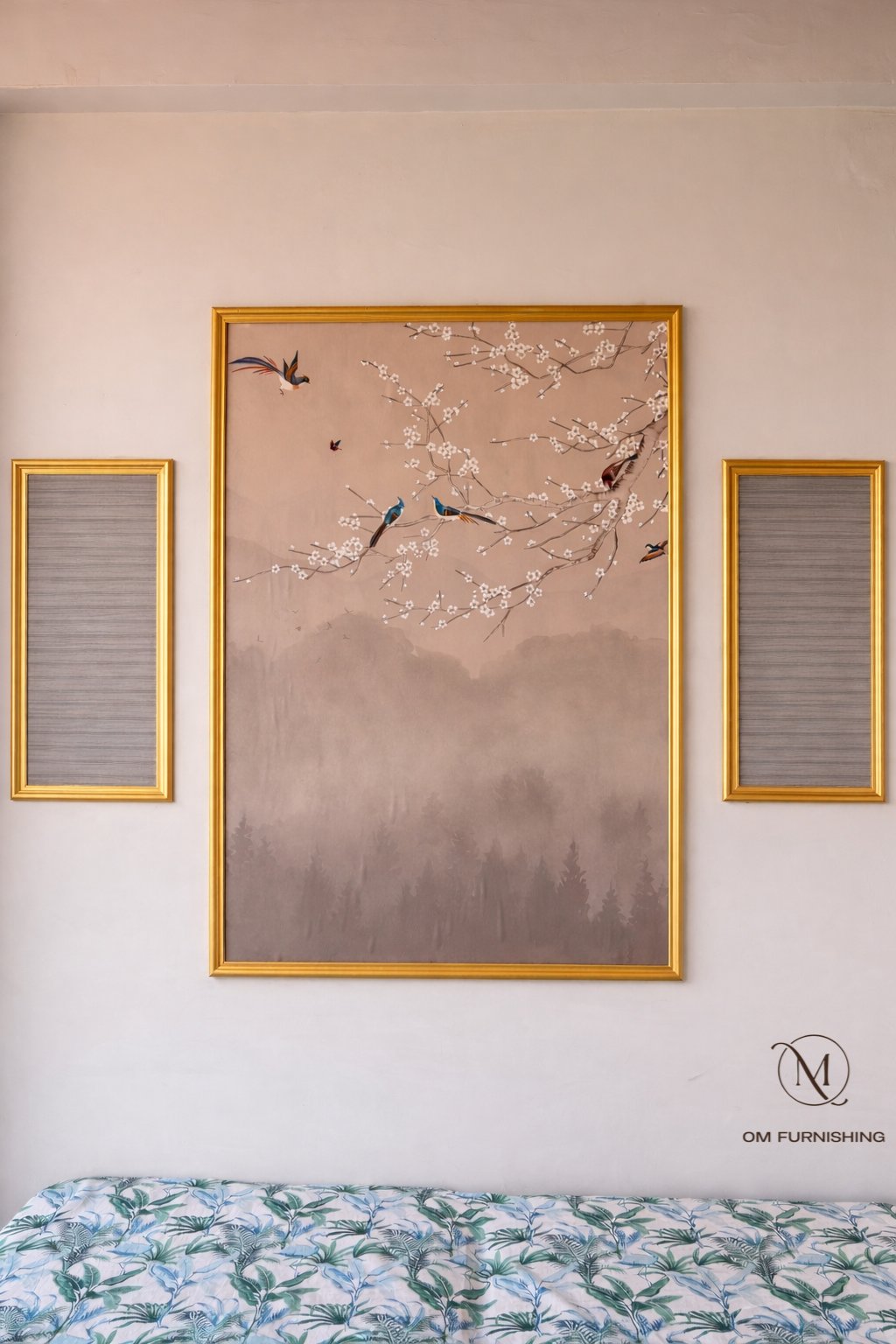 Framed triptych wall art above a bed